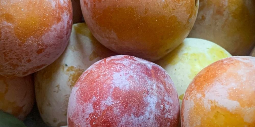 a pile of glazed donuts sitting on top of each other